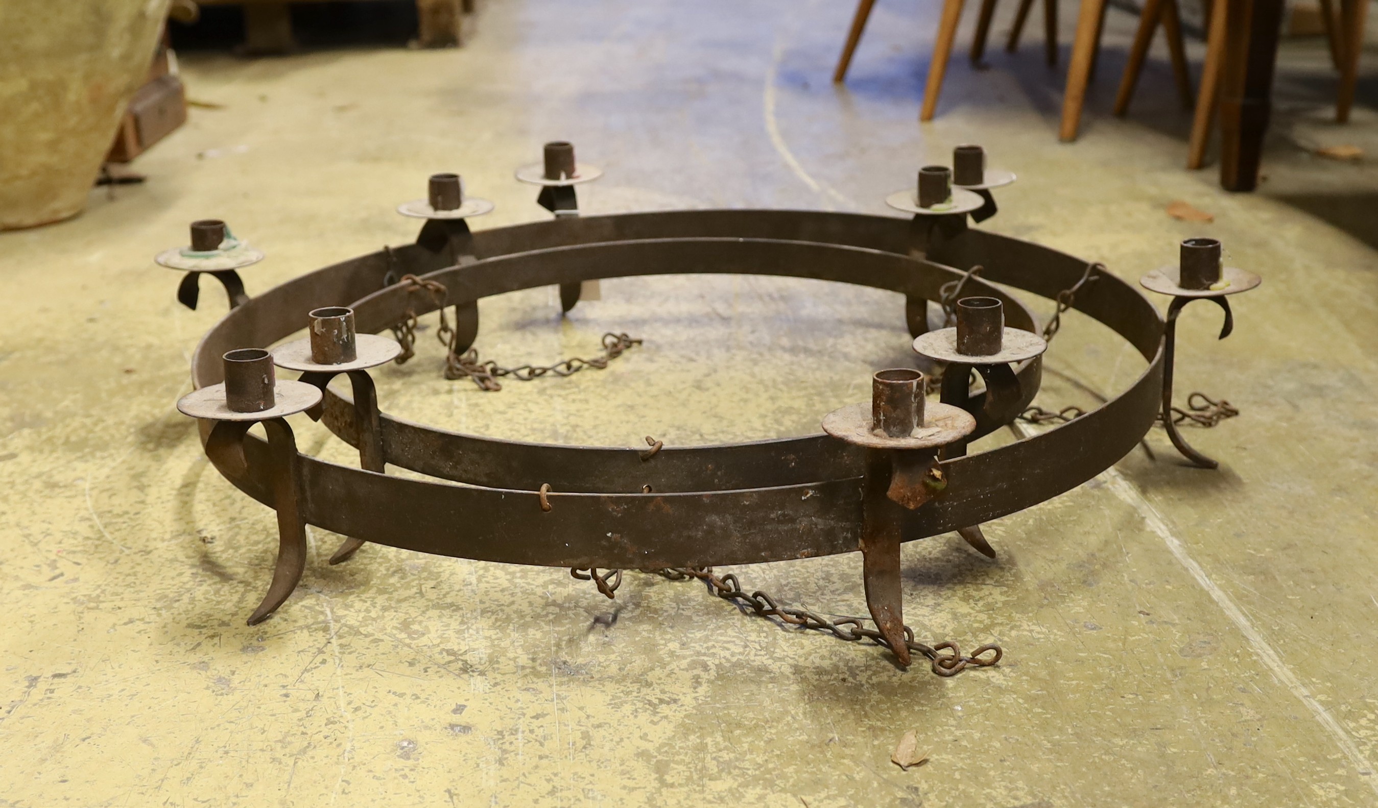 A wrought iron circular two tier hanging candle holder, diameter 76cm